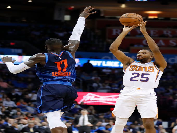 Oct 28, 2018; Oklahoma City, OK, USA; Phoenix Suns forward Mikal Bridges (25) shoots as Oklahoma City Thunder guard Dennis Schroder (17) defends during the second quarter at Chesapeake Energy Arena. Mandatory Credit: Alonzo Adams-USA TODAY Sports