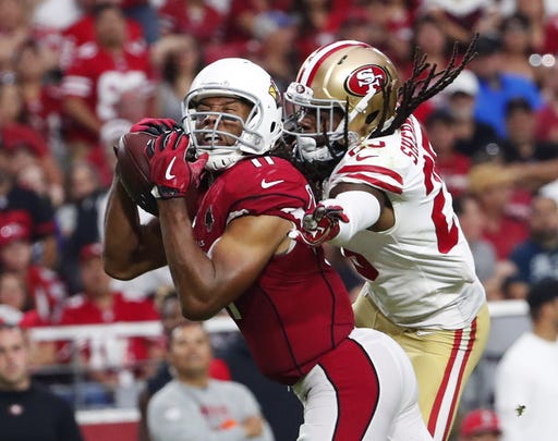 Arizona Cardinals wide receiver Larry Fitzgerald (11) catches a pass against San Francisco 49ers cornerback Richard Sherman (25) in the fourth quarter during NFL action on Oct. 28 at State Farm Stadium.