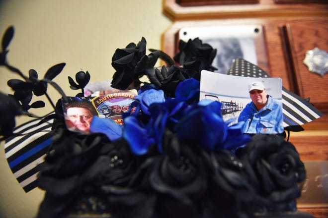 Photos and flowers of RJ Johnson are in the lobby of the South Dakota State Penitentiary before Rodney Berget is executed Monday, Oct. 29, in Sioux Falls.