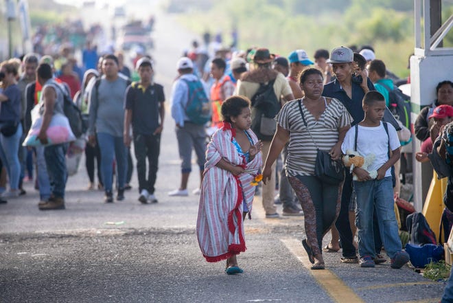 The caravan of migrants pass through Tapanatepec, Oaxaca, Mexico on Monday.
