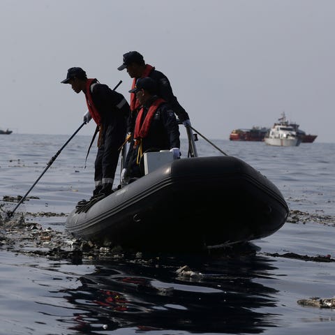 Rescuers conduct search operation in the waters...