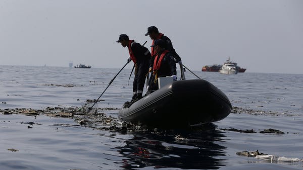 Rescuers conduct search operation in the waters...