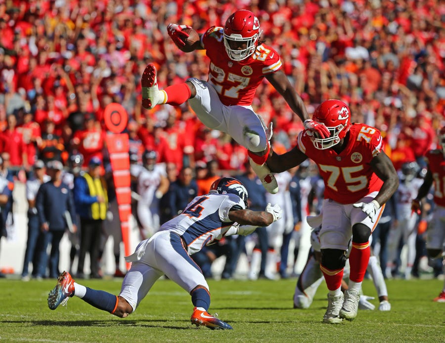 Kareem Hunt  hurdles Broncos safety Will Parks en route to the end zone.
