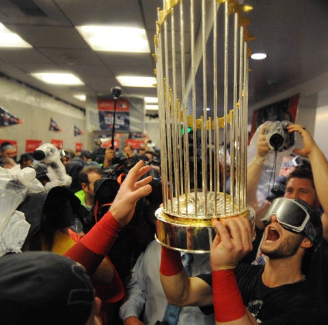 Red Sox players celebrate in the clubhouse after...