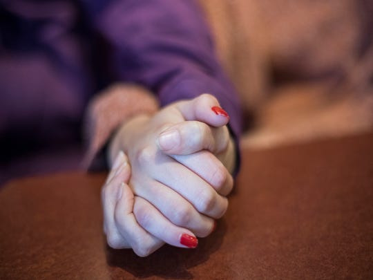 Amber, right, holds her mother Maggie's hand during an interview with the Detroit Free Press.