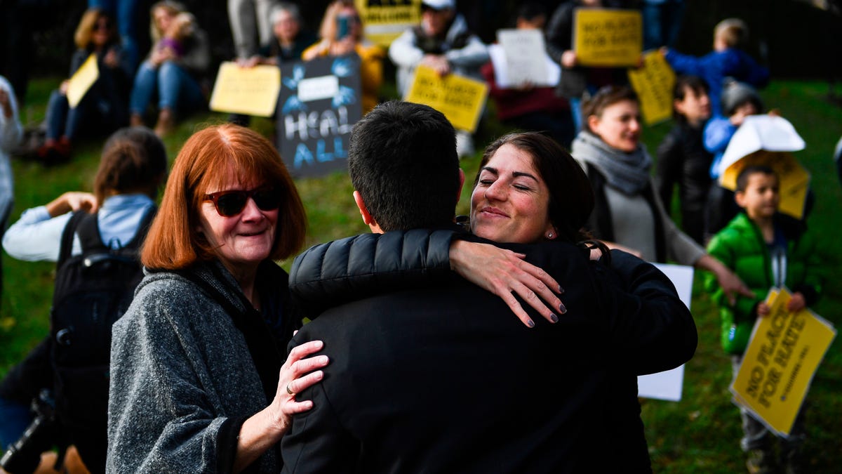 Protesters hug near the Tree of Life Congregation on October 30, 2018, in Pittsburgh, Pennsylvania.