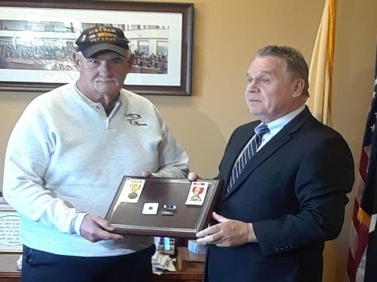 Rep. Chris Smith (right) presents replacement medals to Bernard Ebner.