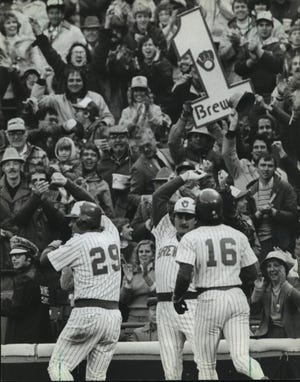 Mark Brouhard (29) got a "high five" from Jim Gantner after hitting a two-run homer in the eighth inning to give the Brewers an extra edge in their 9-5 victory Saturday over the California Angels. At right was Marshall Edwards, who scored ahead of Brouhard.