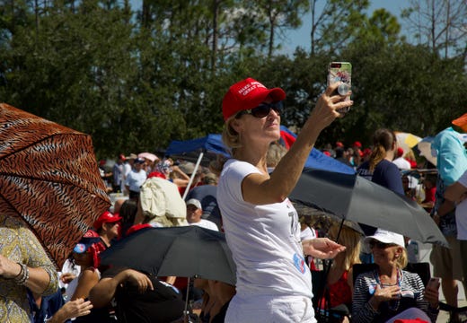 Fort Myers resident Lisa Belcher captures the scene at the Make America Great Again rally at Hertz Arena in Estero on Wednesday, Oct. 31, 2018.
