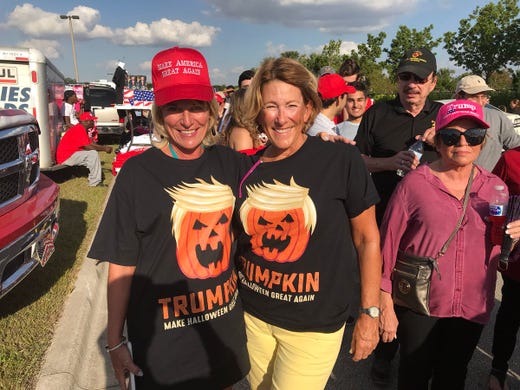 Here is Nancy Bradley, a 59-year-old resident of Naples, and Denise Porter, a 54-year-old resident of Naples. They are celebrating Halloween at the rally with their âTrumpkinâ shirts.
