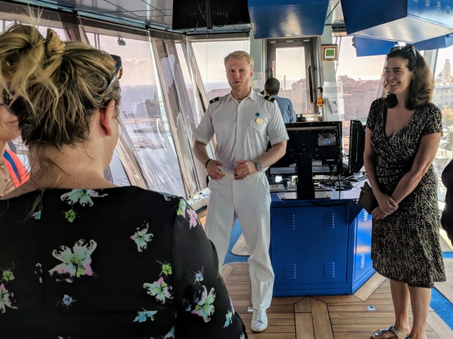 Travel writers including Brittany Anas, left, from Denver and Allison Tibaldi from New York City receive a tour and briefing on the bridge of the Crown Princess from 3rd Officer James Chalu.