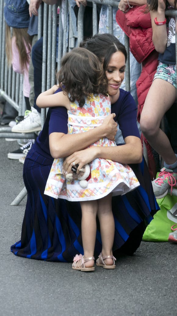 The Duchess Meghan hugs a small 2-year-old Catalina Rivera, who crossed the balustrades during a walk in the Government Gardens on October 31, 2018 in Rotorua, New Zealand.