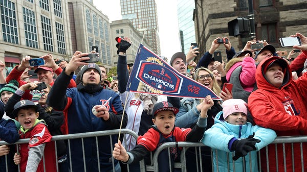Fans cheer during the parade in Boston.
