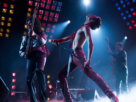 Queen bandmates Brian May (Gwilym Lee, left), Freddie Mercury (Rami Malek) and John Deacon (Joe Mazzello) perform in one of the many concert sequences in 