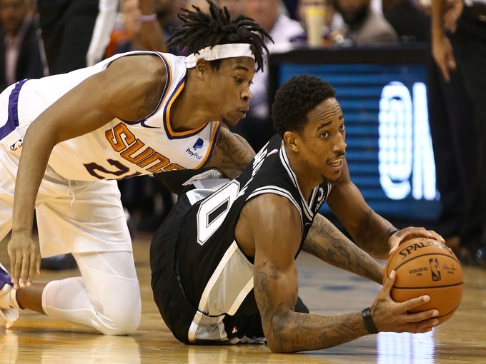 Phoenix Suns forward Richaun Holmes battles for the ball with San Antonio Spurs' DeMar DeRozan in the first half on Oct. 31 at Talking Stick Resort Arena.