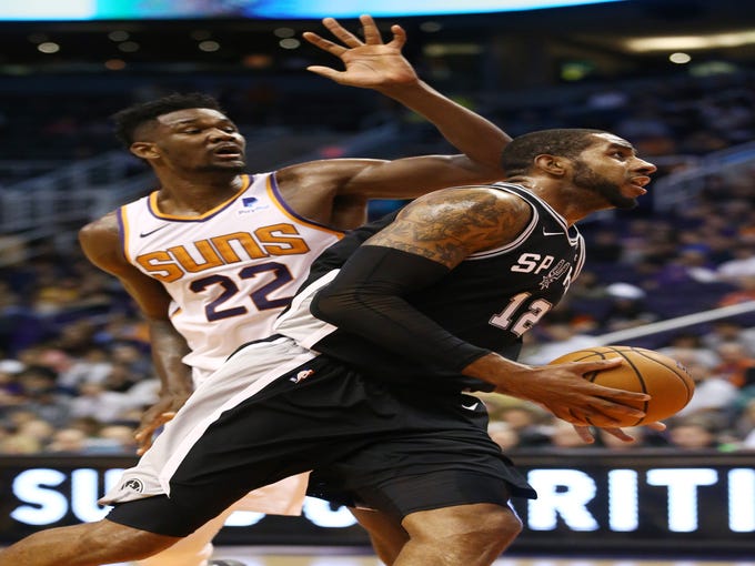 San Antonio Spurs forward LaMarcus Aldridge drives and score past Phoenix Suns' Deandre Ayton in the second half on Oct. 31 at Talking Stick Resort Arena.
