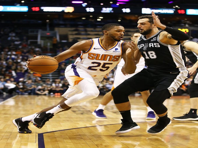 Phoenix Suns forward Mikal Bridges drives against San Antonio Spurs' Marco Belinelli in the first half on Oct. 31 at Talking Stick Resort Arena.