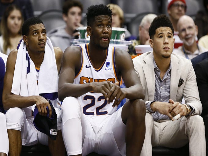 Phoenix Suns De'Anthony Melton, Deandre Ayton and Devin Booker watch during their 120-90 loss to the San Antonio Spurs on Oct. 31 at Talking Stick Resort Arena.