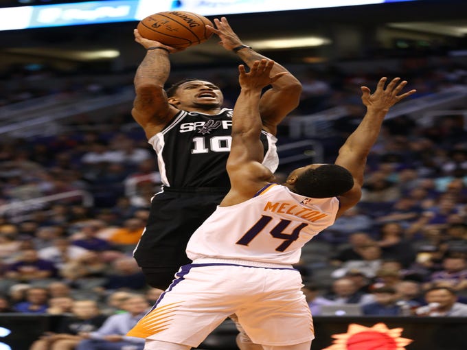 San Antonio Spurs 	guard DeMar DeRozan shoots over Phoenix Suns' De'Anthony Melton in the second half on Oct. 31 at Talking Stick Resort Arena.