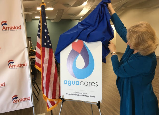 The logo for the new AguaCares program is unveiled at a news conference.