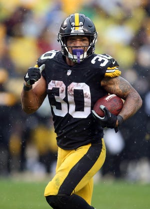 Pittsburgh Steelers running back James Conner (30) rushes the ball against the Cleveland Browns during the fourth quarter at Heinz Field.