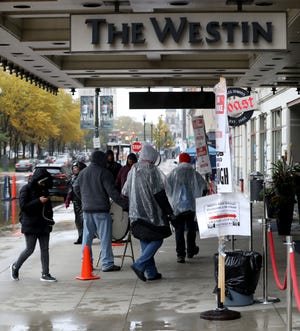Over 130 workers in unions in Detroit have been on strike in front of the Westin Book Cadillac for the past month. Under the rain on Thursday, November 1, 2018, a handful of them march in front of the main entrance to the sound of a beating drum.