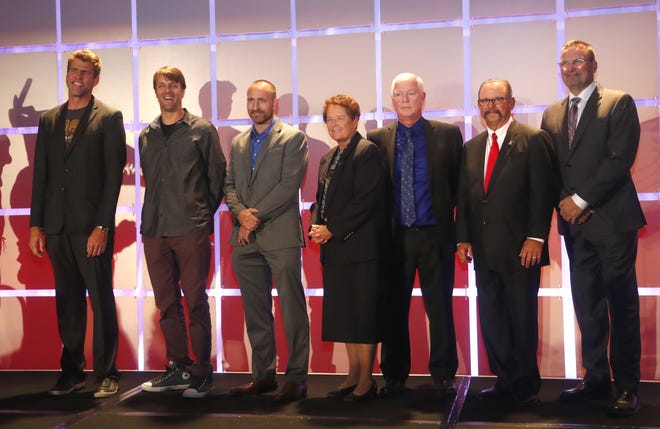 The 2018 Arizona Sports Hall of Fame inductees Gary Hall Jr. (L-R), Jake Plummer and Kevin Tillman representing Kevin's brother Pat Tillman, Sister Lynn Winsor, Jeff Oscarson, Mike Candrea and Mark Grace line up for a picture before their ceremony at the Scottsdale Plaza Resort in Scottsdale, Ariz. on November 1, 2018.