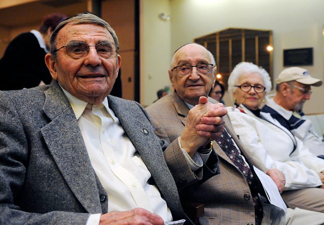 Holocaust survivors Izzy Randel and Murray Ressler clasp hands at Beth Israel Congregation in Vineland in honor of their six decade friendship.