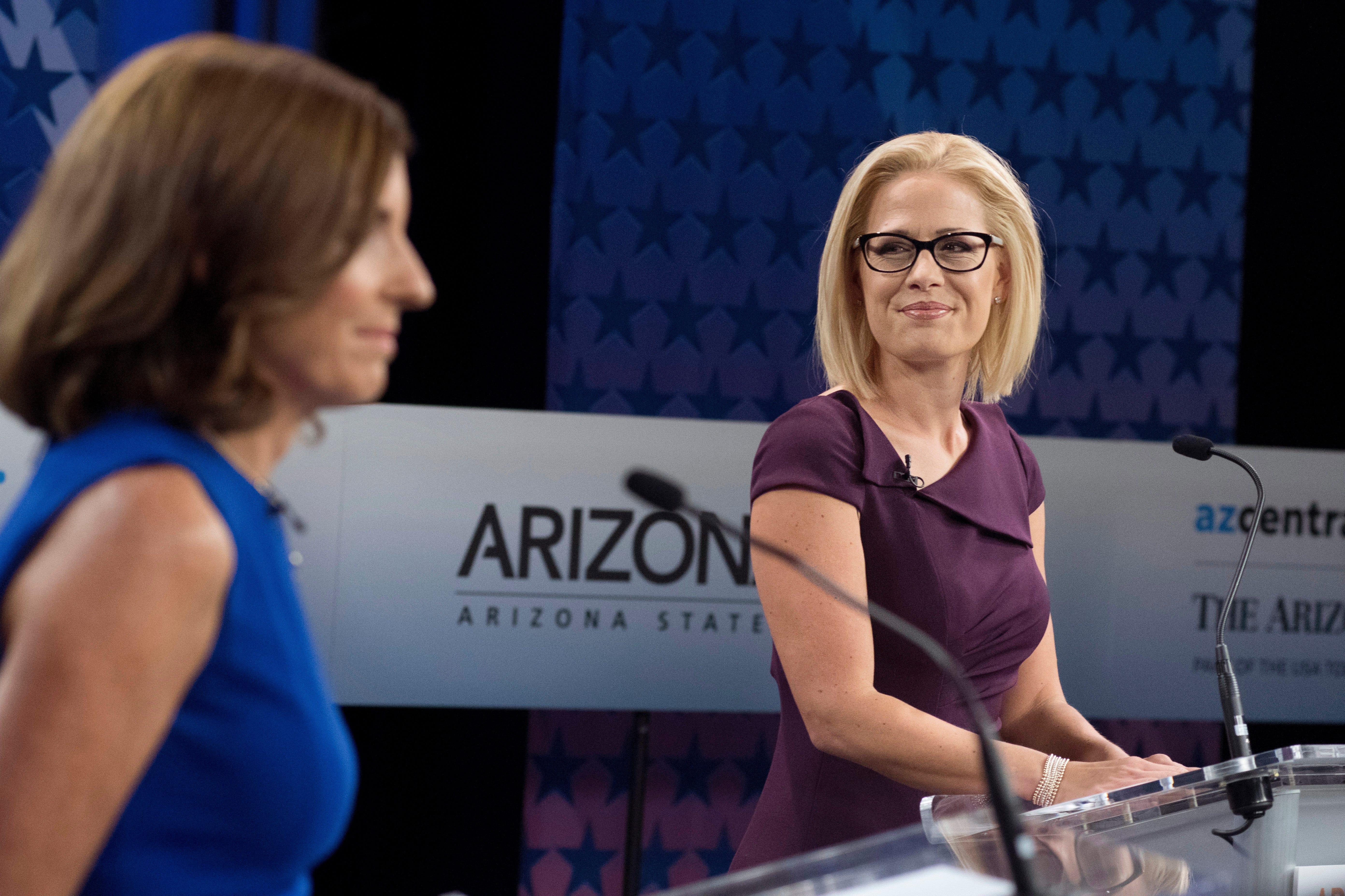 Republican Senate candidate Martha McSally (L) and Democratic Senate candidate Kyrsten Sinema (R) prepare to debate at the studios of the KAET public television station in Phoenix on Oct. 15, 2018.