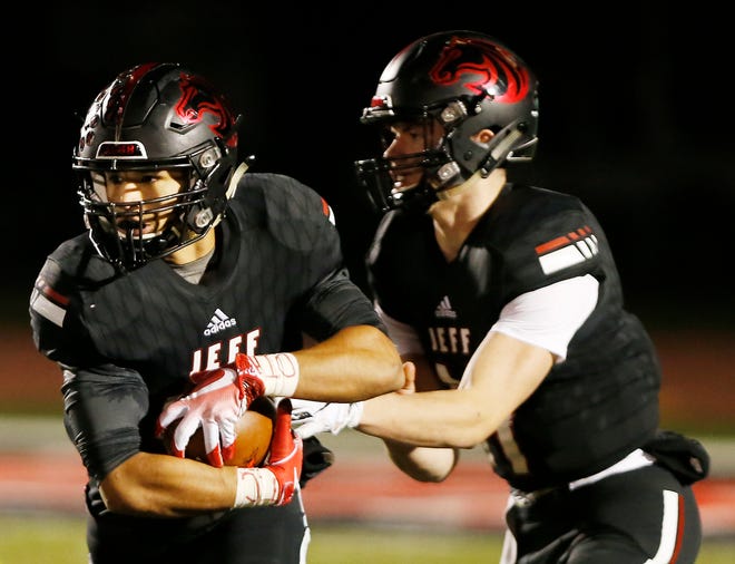Marquis Munoz of Lafayette Jeff takes a handoff from quarterback Maximus Grimes against Carmel Friday, November 2, 2018, in Lafayette. The Bronchos fell to Carmel 41-21.