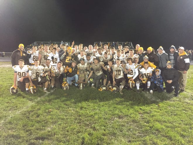 Monroe Central poses with the trophy after defeating Union City 29-0 for the sectional championship.