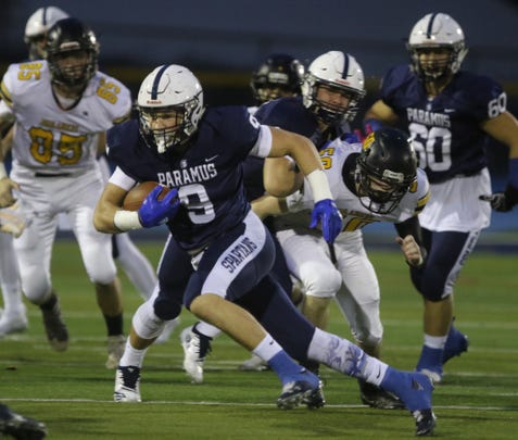 Kyle Jacob of Paramus runs the ball for a long gain to setup his team's first TD in the first half.
