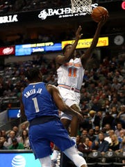DALLAS, TEXAS - NOVEMBER 02:  Frank Ntilikina #11 of the New York Knicks takes a shot against Dennis Smith Jr. #1 of the Dallas Mavericks at American Airlines Center on November 02, 2018 in Dallas, Texas.