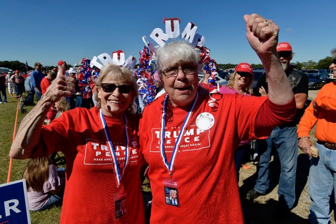 Debra Menda and Linda Norton prepare for President Donald Trump's rally on Saturday, Nov. 3, 2018, outside the Pensacola International Airport.