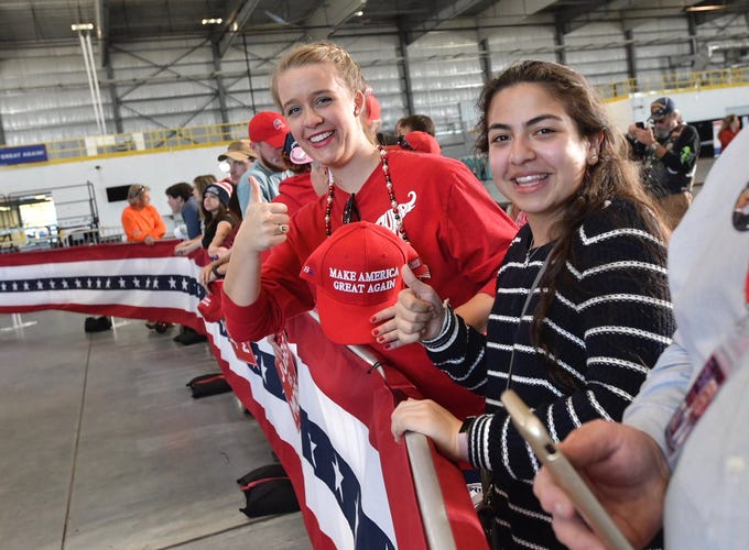 Supporters start grabbing the best spots along to front row at the ST Engineering hangar at Pensacola International Airport in anticipation of President Donald Trump's rally on Saturday, Nov. 3, 2018.