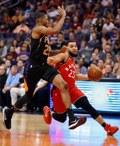 Toronto Raptors guard Fred VanVleet (23) drives past Phoenix Suns forward Mikal Bridges (25) during the first half of an NBA basketball game, Friday, November 2, 2018, in Phoenix. "Data id ="