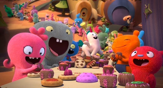 Moxy (pink, voiced by Kelly Clarkson), Babo (gray, voiced by Gabriel Iglesias) and Lucky Bat (red, voiced by Wang Leehom) enjoy a well-balanced meal of cookies and cake.