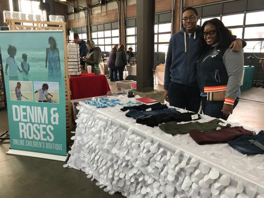 Eboni Chavers, co-founder of the online children's boutique Denim & Roses, poses with her 16-year-old son Javar Chavers at the All Things Detroit shopping experience at Eastern Market on Sunday, Nov. 4, 2018.