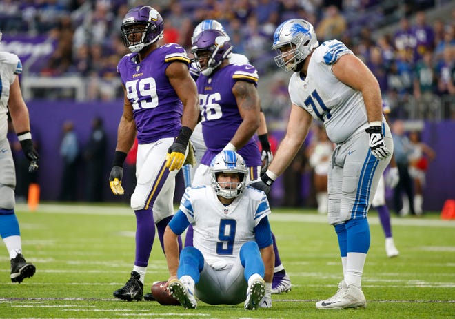Matthew Stafford sits on the field next to Rick Wagner, after getting sacked by Vikings defensive end Danielle Hunter (99) during the first half of the Lions' 24-9 loss Sunday, Nov. 4, 2018, in Minneapolis.
