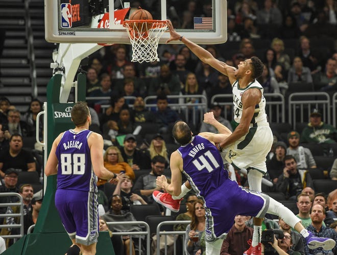 Giannis Antetokounmpo finishes a drive to the bucket by posterizing Kosta Koufos of the Kings with an emphatic dunk during the third quarter Sunday.