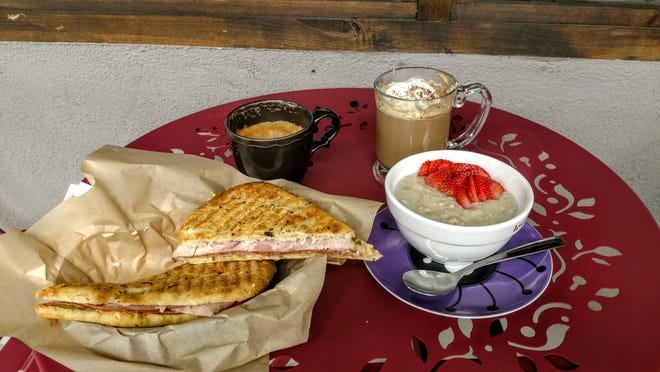 From left: When Pigs Fly Panini ; Peppermint Mocha; Lavender Vanilla Mocha with whipped cream and cocoa powder; and the Steel Cut Oats with Strawberries at Moms Coffee.