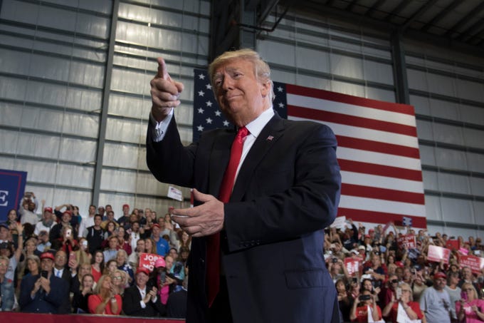 President Donald Trump smiles at the crowd Saturday, Nov. 3, 2018, during his rally at the ST Engineering hangar at the Pensacola International Airport.