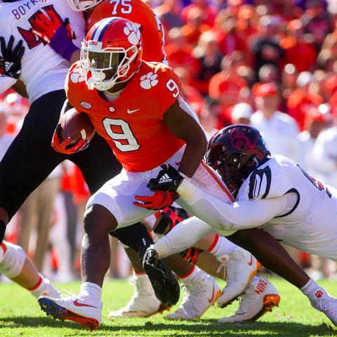 Clemson running back Travis Etienne  carries the...