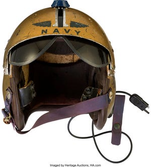 This undated photo provided by Heritage Auctions shows a helmet worn by John Glenn during the history-making flight, dubbed Project Bullet, in which the future astronaut set the transcontinental speed record in 1957.  Artifacts owned by the late Neil Armstrong will be offered for sale by Dallas-based Heritage Auctions starting Thursday, Nov. 1, 2018,  including pieces of a wing and propeller from the 1903 Wright Flyer the astronaut took with him to the moon in 1969.   (Courtesy of Heritage Auctions via AP)