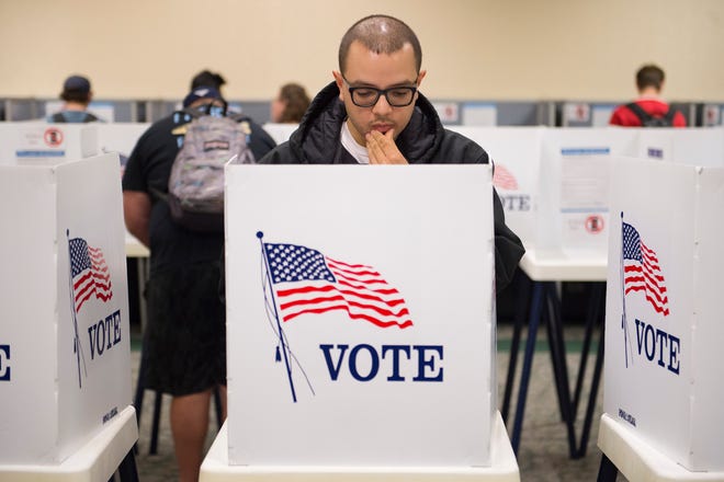 Matthew Moreno looks over his choices in the voting booth during early voting at CSU's Lory Student Center on Monday, November 5, 2018. Election judges said a steady stream of students were turning out to vote the day before Election Day. 