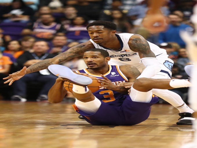 Nov 4, 2018; Phoenix, AZ, USA; Phoenix Suns forward Trevor Ariza (3) battles for a loose ball against Memphis Grizzlies guard MarShon Brooks (8) in the first half at Talking Stick Resort Arena.