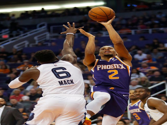 Phoenix Suns guard Elie Okobo shoots over Memphis Grizzlies guard Shelvin Mack (6) in the second half during an NBA basketball game, Sunday, Nov. 4, 2018, in Phoenix. The Suns defeated the Grizzlies 102-100.