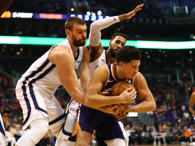 Nov 4, 2018; Phoenix, AZ, USA; Phoenix Suns guard Devin Booker (right) battles for the ball against Memphis Grizzlies center Marc Gasol (left) in the second half at Talking Stick Resort Arena.