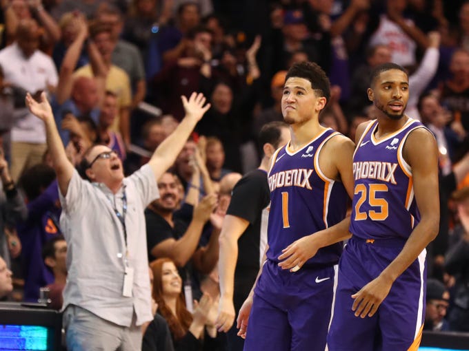 Nov 4, 2018; Phoenix, AZ, USA; Phoenix Suns guard Devin Booker (1) is congratulated by teammate Mikal Bridges after hitting the game winning basket in the closing seconds of the game against the Memphis Grizzlies at Talking Stick Resort Arena.