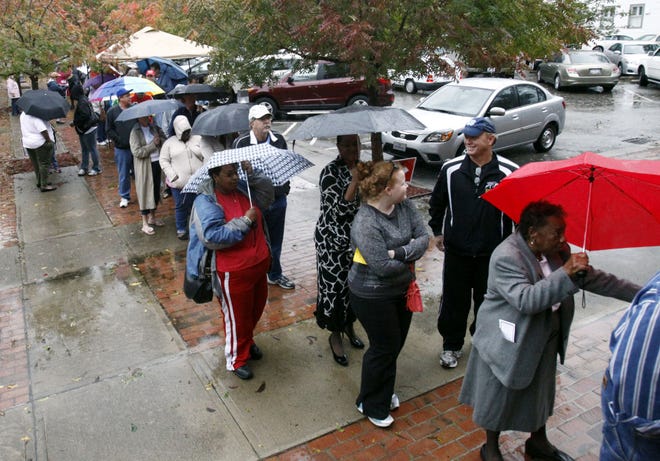 Voters wait in line despite rains from Hurricane Sandy to vote on the last early voting Sunday before Election Day, in New Bern, N.C., on Oct. 28, 2012.  In 2018, a rainy Election Day is expected in the East.
